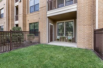 our apartments offer a patio with chairs and a lawn